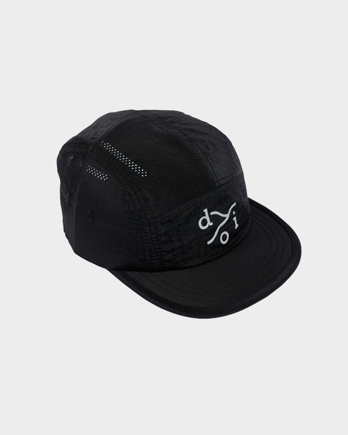 A black five-panel camp cap with a reflective logo on the front, displayed against a light gray background.