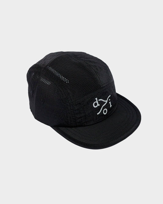 A black five-panel camp cap with a reflective logo on the front, displayed against a light gray background.